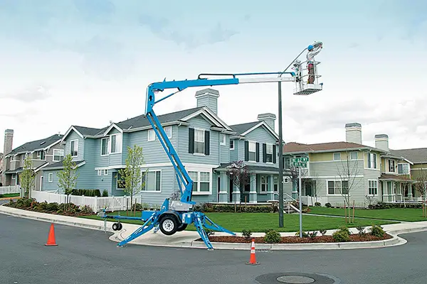Dade trailer mounted cherry picker lift working on residential building roof