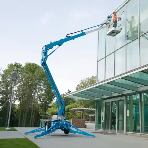 Dade towable articulated trailer mounted boom lift performing commercial glass cleaning