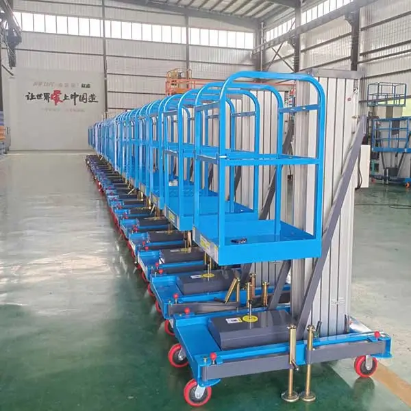 DADE Machinery aluminum mast lift platforms lined up on the indoor factory floor