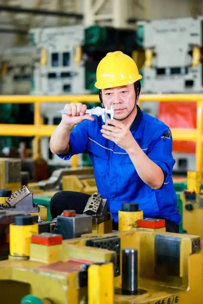 DADE Machinery QA specialist measuring component precision for hydraulic scissor lifts