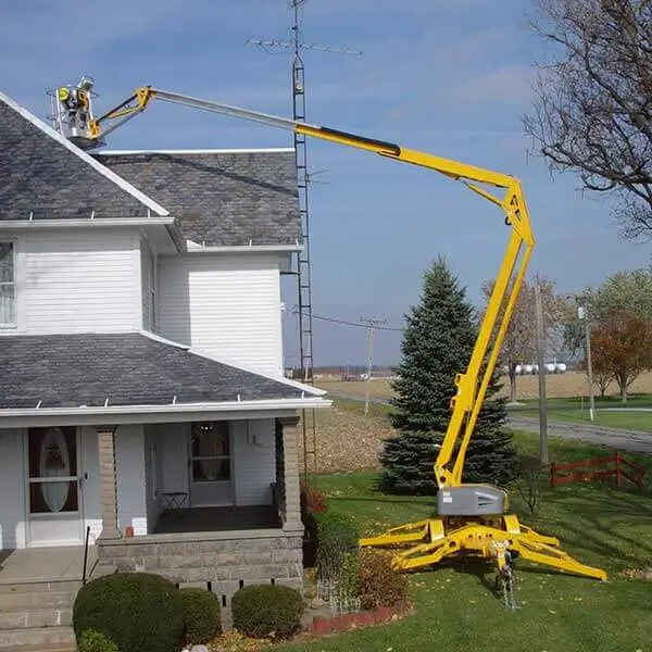 High reach yellow towable boom lift for high suburban roofing