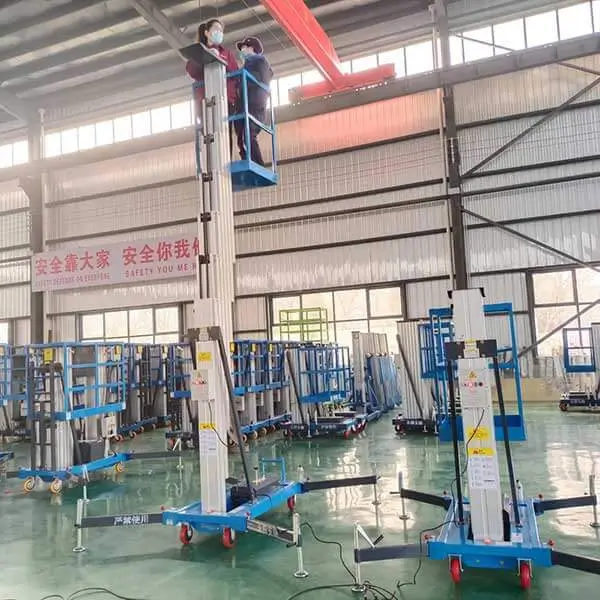 Operator using single mast aluminum lift for indoor ceiling maintenance