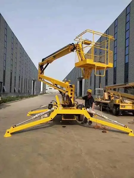 Yellow articulating boom lift performing commercial building maintenance