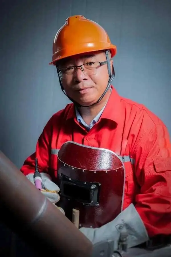 DADE Machinery production line worker welding heavy-duty steel chassis for boom lifts