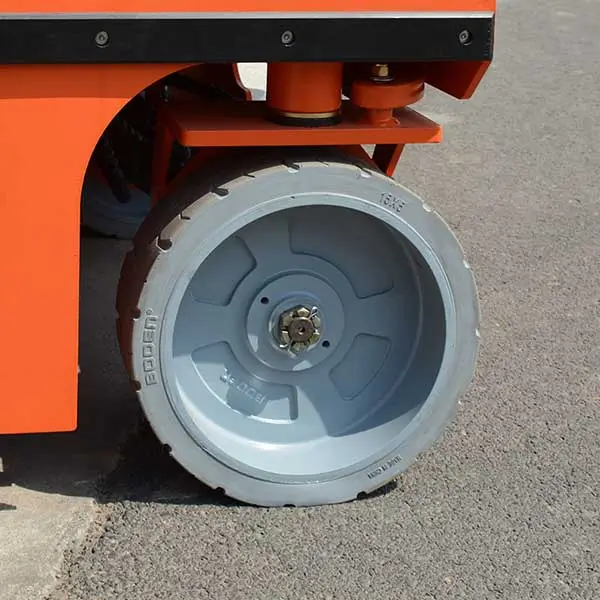 Non-marking solid rubber steering drive tire on electric scissor lift chassis